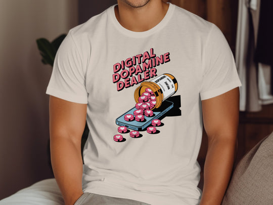 Person wearing a natural color t-shirt with a graphic design of a bottle labeled 'Digital Dopamine Dealer' and pink pills.