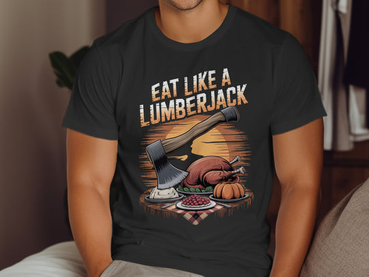 Person wearing a black t-shirt with a graphic design and text 'Eat Like a Lumberjack'.