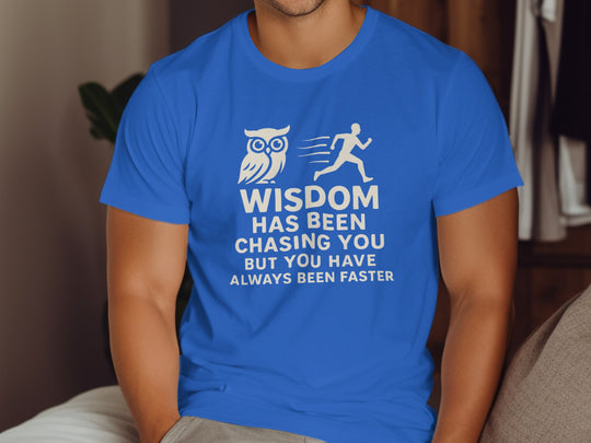 Person wearing a blue t-shirt with an owl and running man graphic and text.
