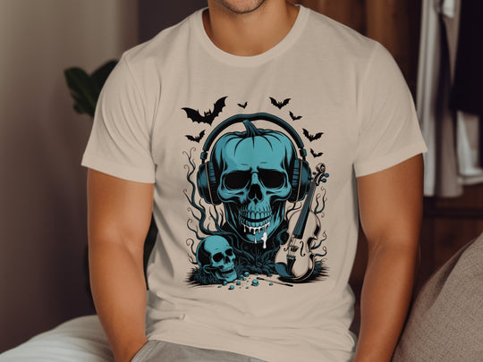 Person wearing a sand color t-shirt with a blue skull and guitar design.