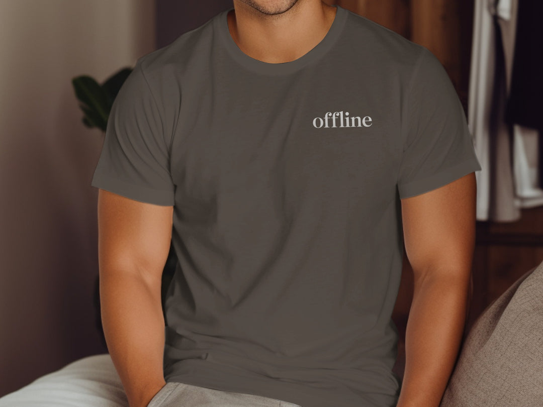 Person wearing a dark chocolate t-shirt with 'offline' text in a home setting