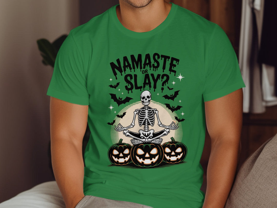 Person wearing a green t-shirt with a Halloween-themed design featuring a skeleton and pumpkins.