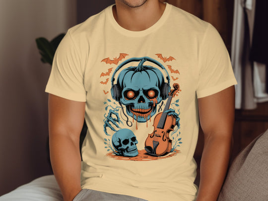 Person wearing a yellow haze t-shirt with a Halloween-themed design featuring skulls and a violin.