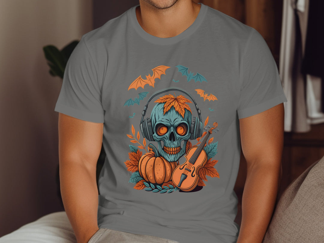 Person wearing a charcoal t-shirt with a Halloween-themed design featuring a skull, pumpkin, and violin.
