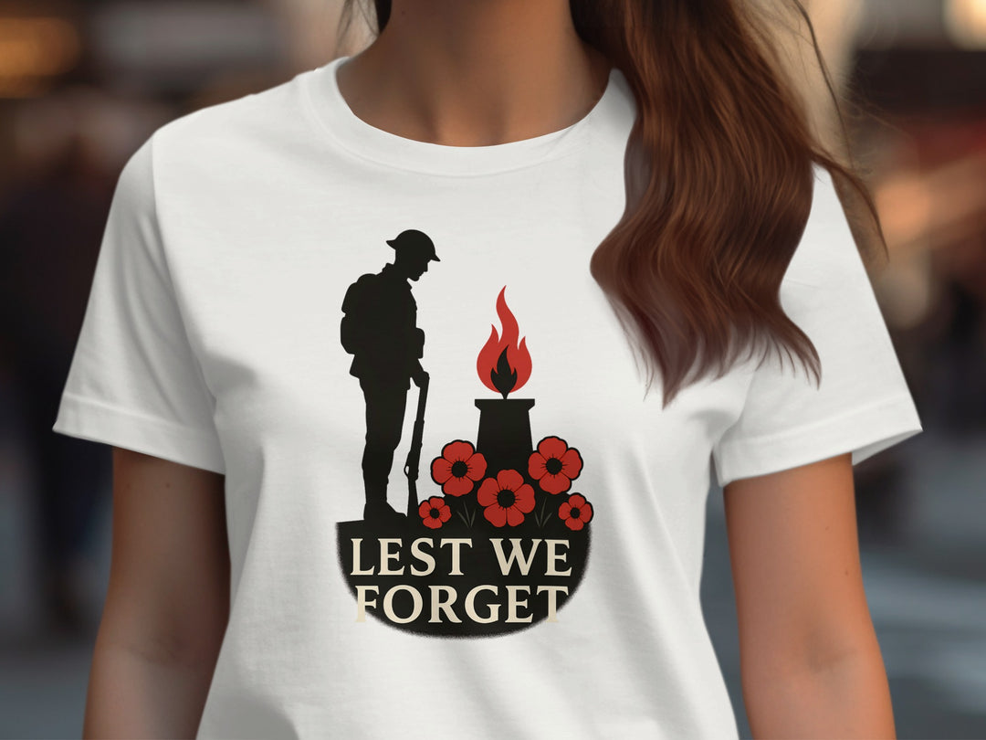 Off White t-shirt with a silhouette design of a soldier, candle, and flowers with 'Lest We Forget' text.