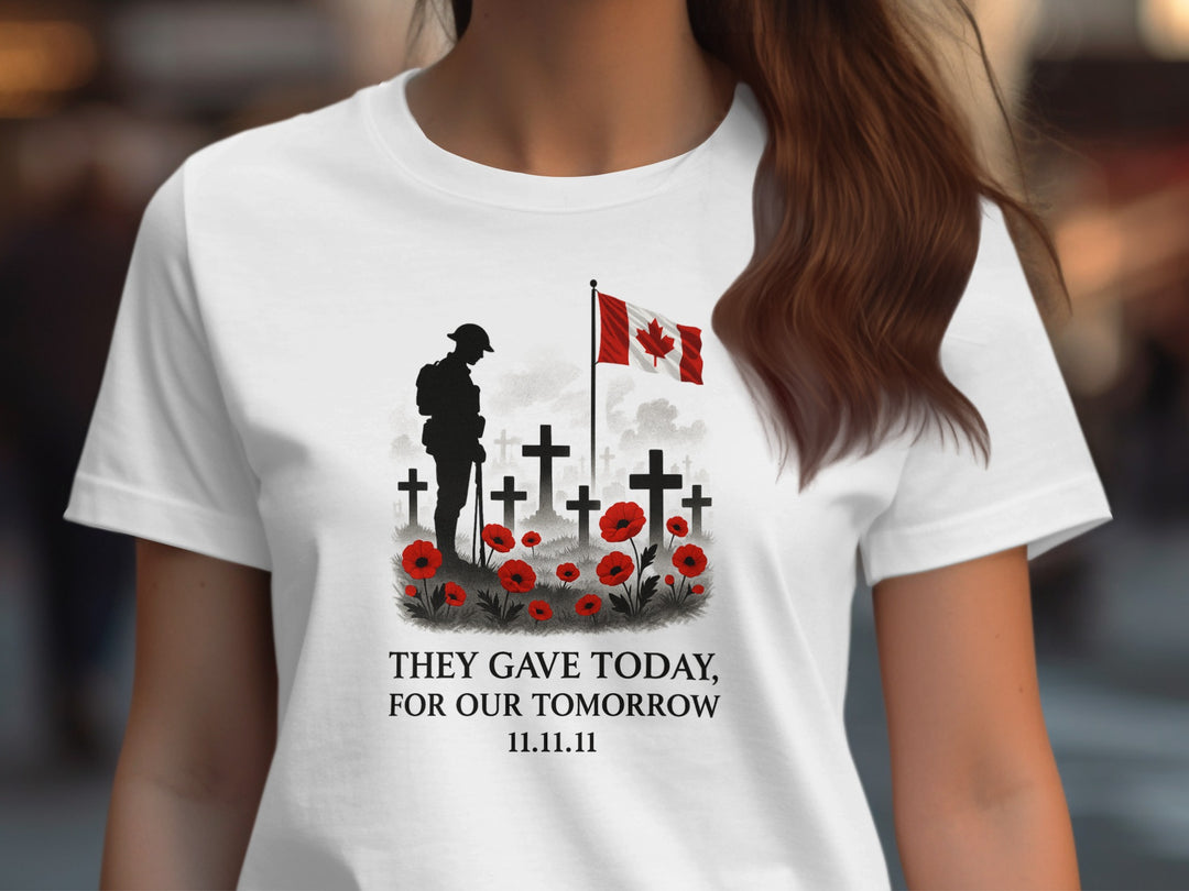 White t-shirt with a memorial design featuring a soldier, crosses, and a Canadian flag.