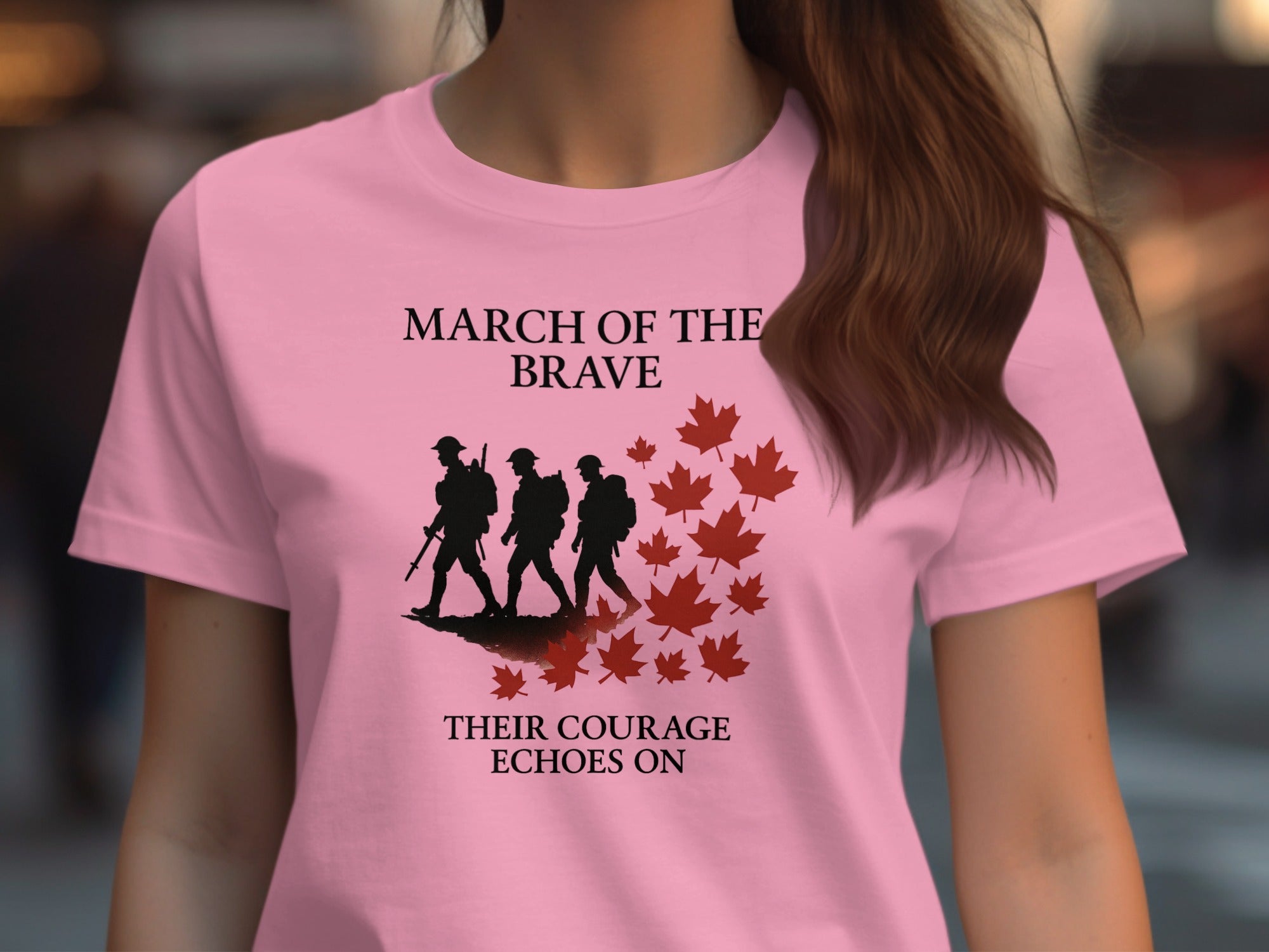 Pink t-shirt with military-themed design and text, worn by a person.