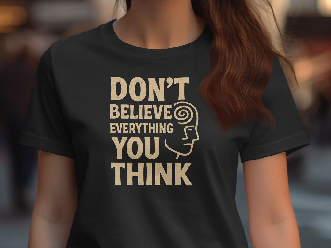 Person wearing a black t-shirt with a motivational quote and graphic design.