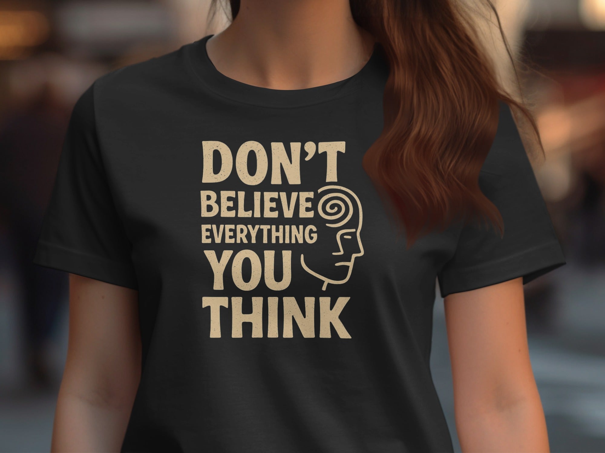 Person wearing a black t-shirt with a motivational quote and graphic design.