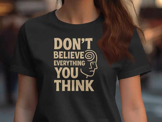 Person wearing a black t-shirt with a motivational quote and graphic design.