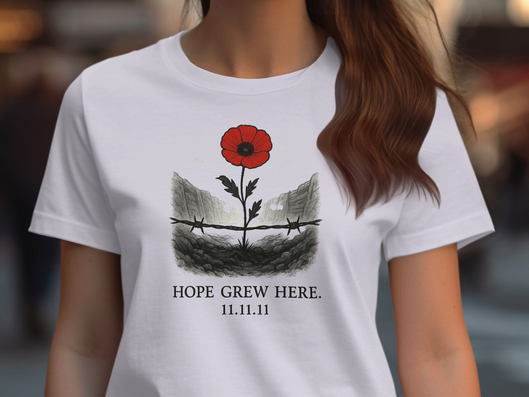 Lavender t-shirt with a red poppy design and text worn by a person.
