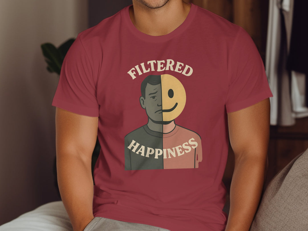 Person wearing a maroon t-shirt with a graphic design and text.