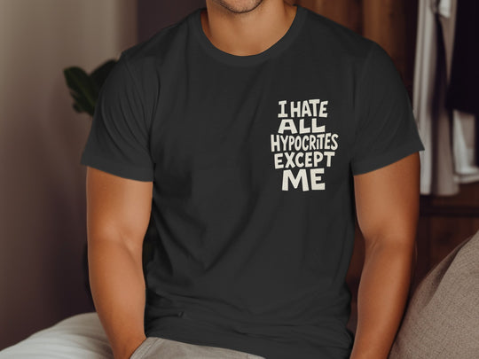 Person wearing a black t-shirt with text sitting on a couch.