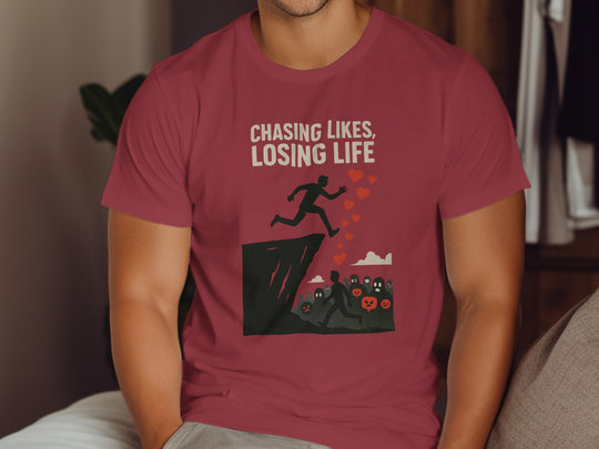 Person wearing a red t-shirt with a graphic design and text.