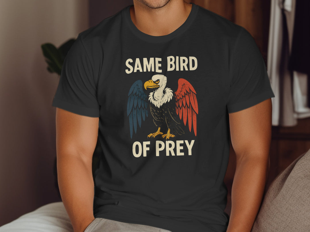 Person wearing a black t-shirt with an eagle graphic and text.