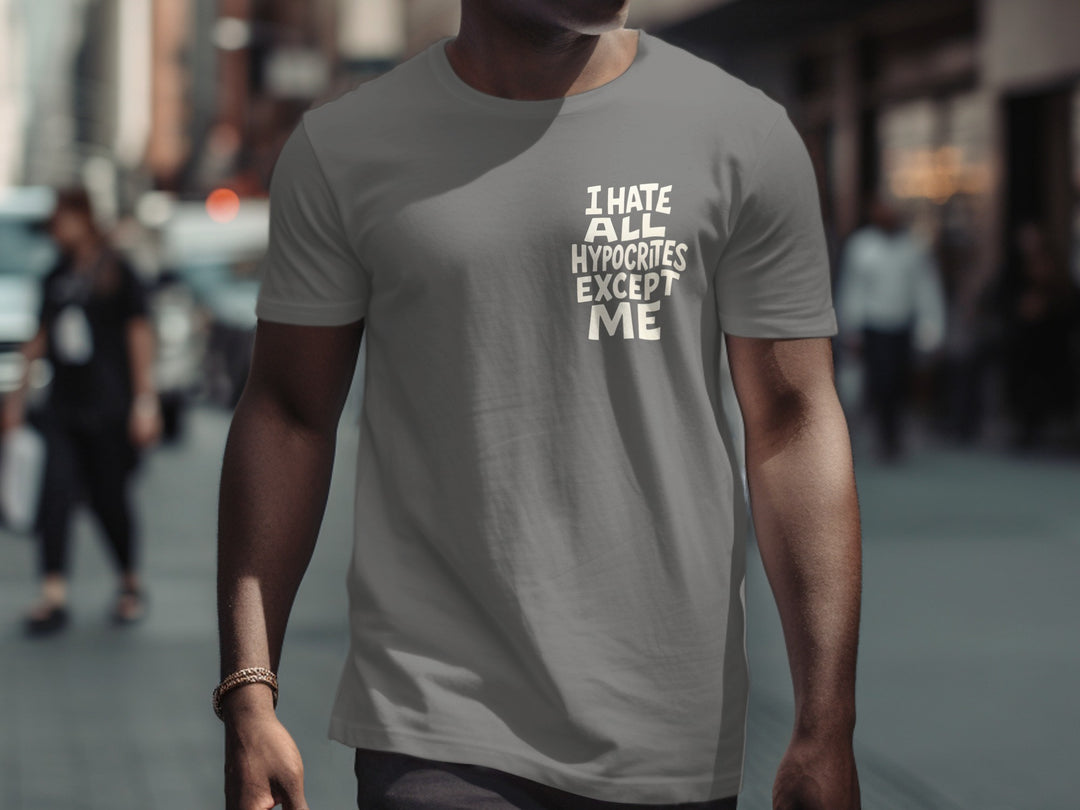 Person wearing a charcoal t-shirt with text on a city street