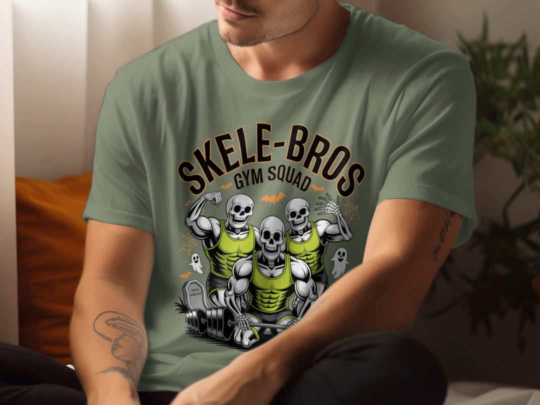 Person wearing a green t-shirt with 'SKELE-BROS GYM SQUAD' design featuring skeletons lifting weights.