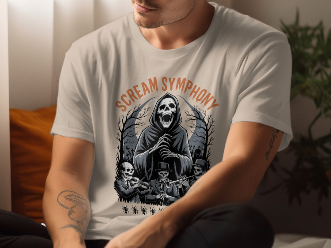 Person wearing a sand color t-shirt with 'Scream Symphony' design featuring a grim reaper and skeletons.