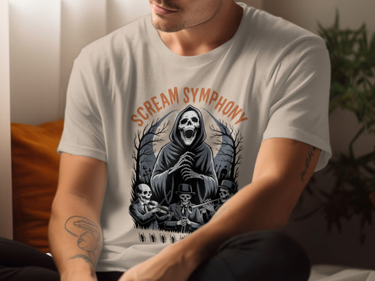Person wearing a sand color t-shirt with 'Scream Symphony' design featuring a grim reaper and skeletons.