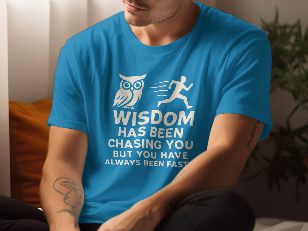Person wearing a sapphire blue t-shirt with a motivational quote and owl graphic.