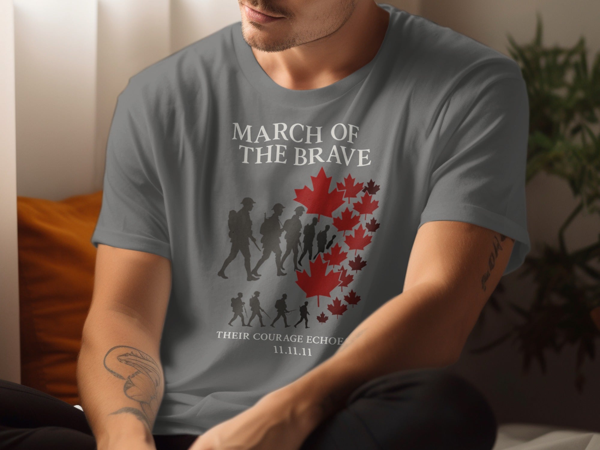 Person wearing a charcoal t-shirt with 'March of the Brave' design featuring silhouettes and a red maple leaf.