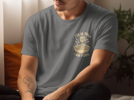 Person wearing a gray t-shirt with a graphic design and text.