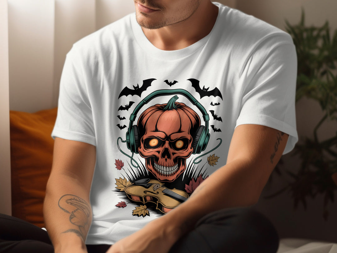 Person wearing a white t-shirt with a graphic design of a pumpkin with a skull face, headphones, and bats.