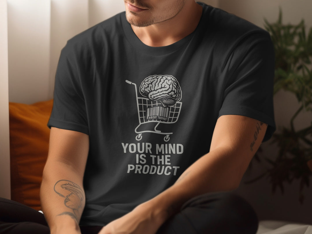 Person wearing a black t-shirt with a graphic and text 'Your Mind is the Product'.