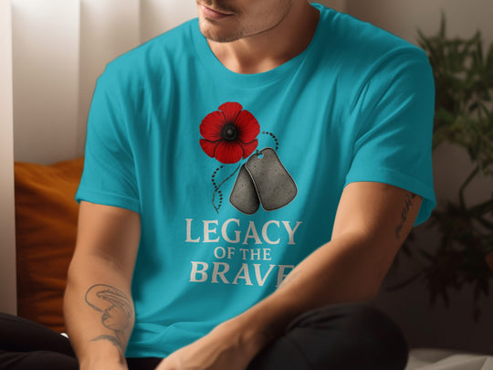 Person wearing a turquoise t-shirt with a red poppy and dog tags design and 'Legacy of the Brave' text.