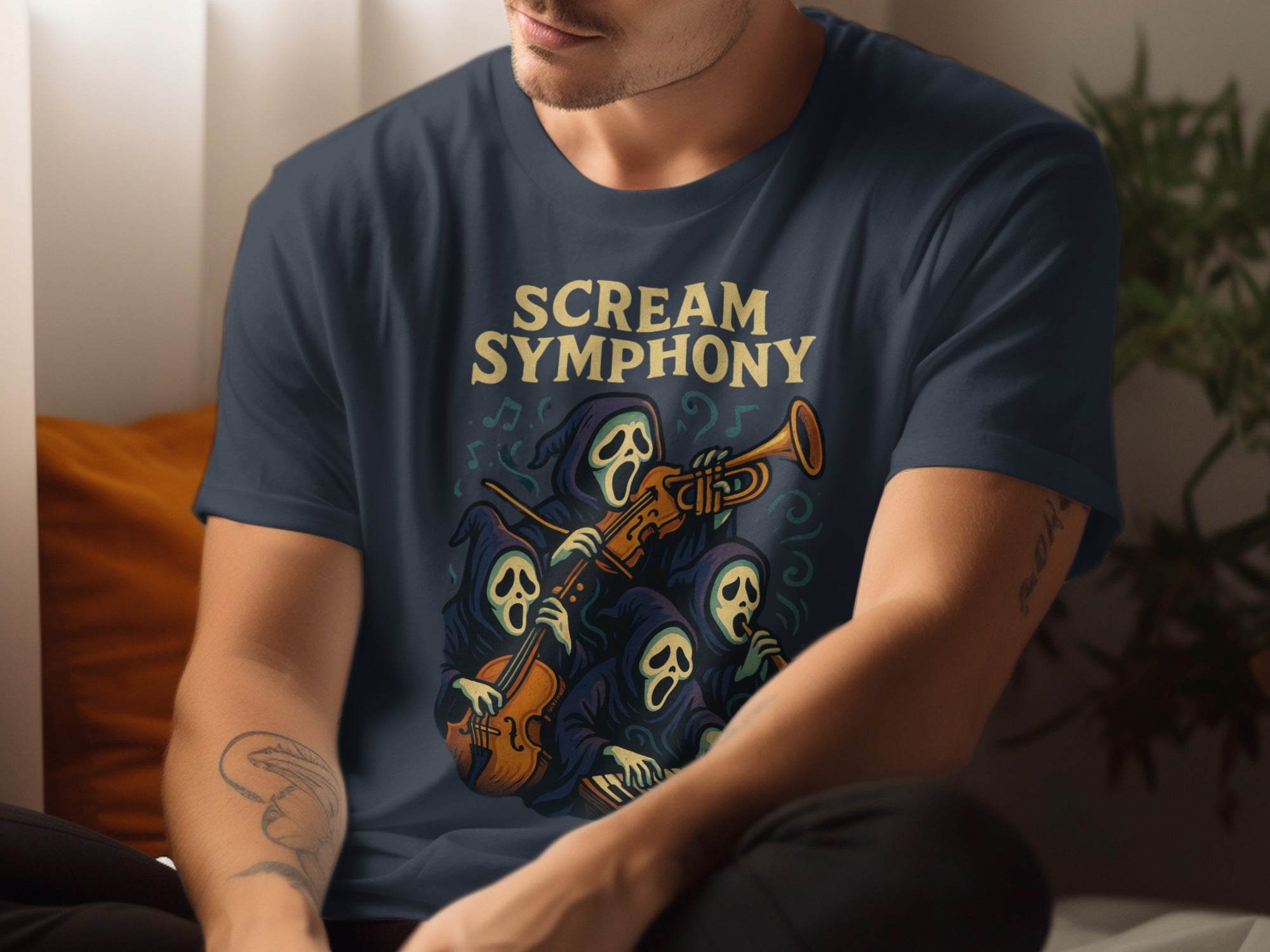 Person wearing a navy blue t-shirt with 'Scream Symphony' design featuring a ghost playing a trumpet.