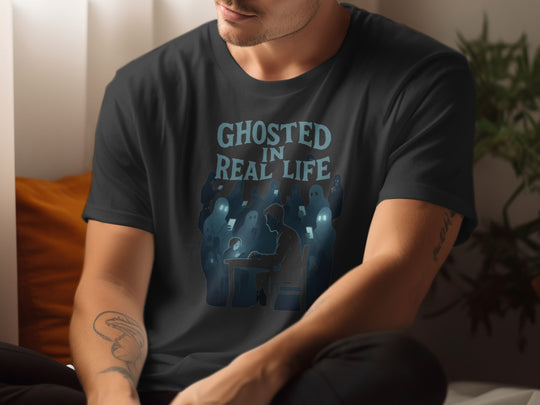 Person wearing a black t-shirt with 'Ghosted in Real Life' graphic design.