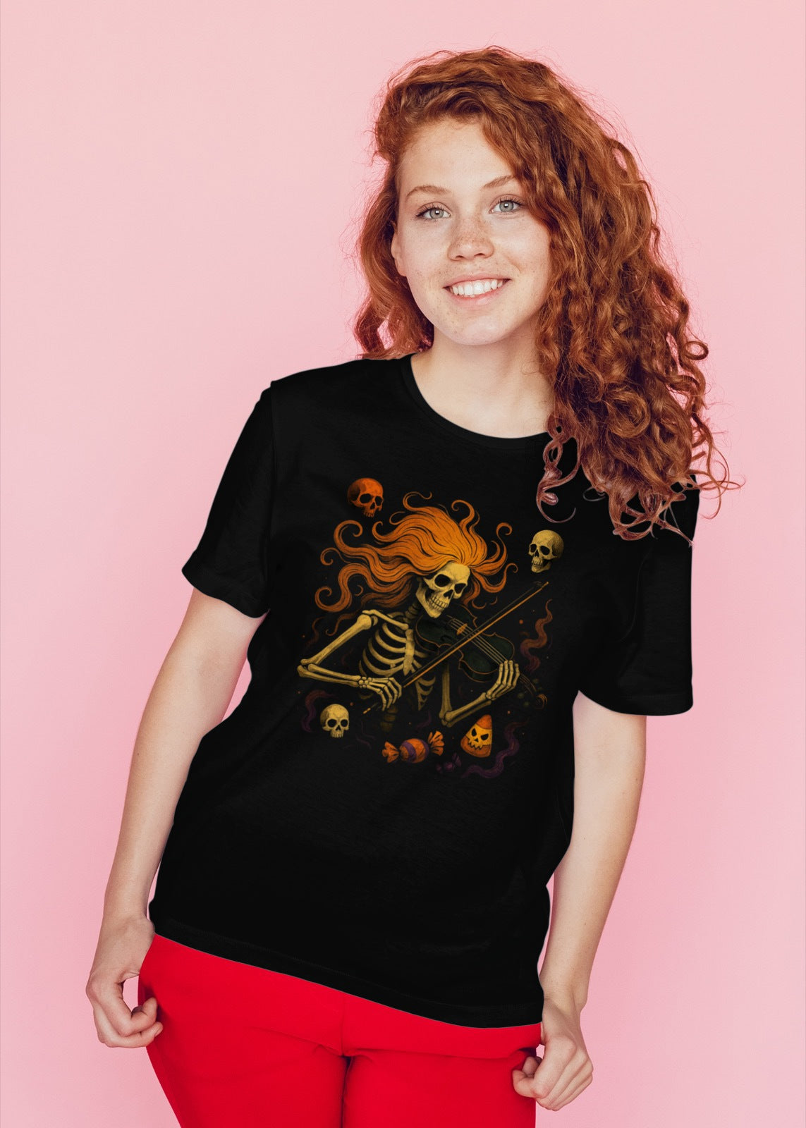 Person wearing a black t-shirt with a skeleton design on a pink background
