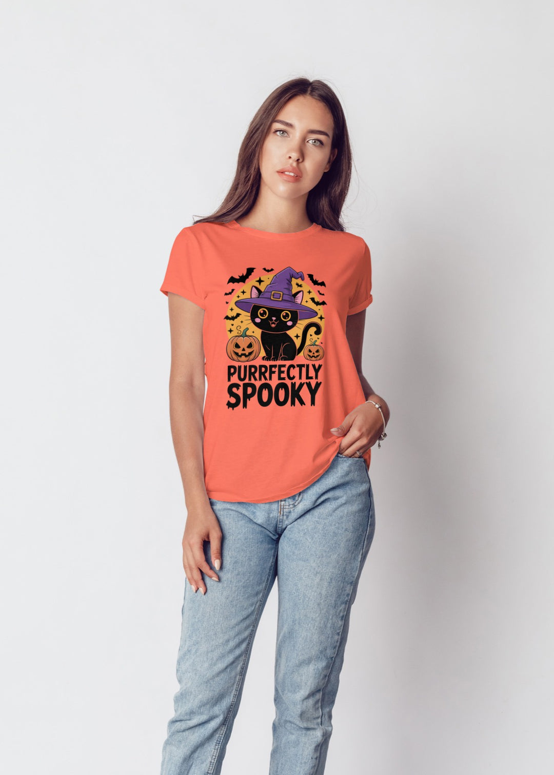 Woman wearing a Halloween-themed t-shirt with a black cat design on a plain background