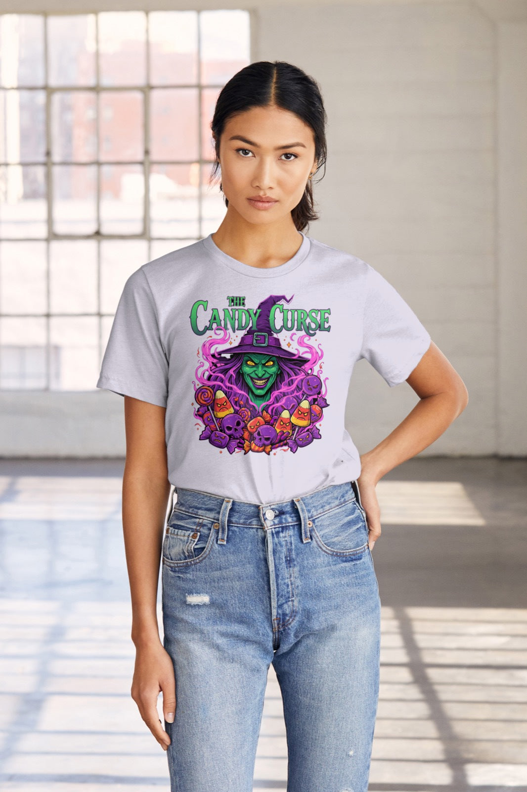 Women wearing a lavender t-shirt with a colorful graphic halloween design in a bright room.