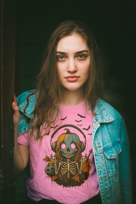 Women wearing a pink t-shirt with a graphic design, standing against a dark background