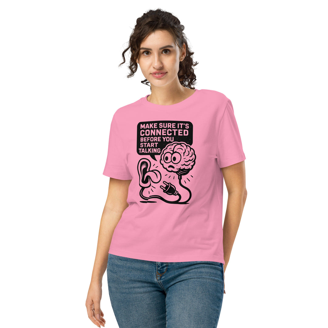 Person wearing a pink t-shirt with a graphic design and text.