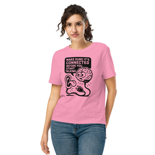 Person wearing a pink t-shirt with a graphic design and text.